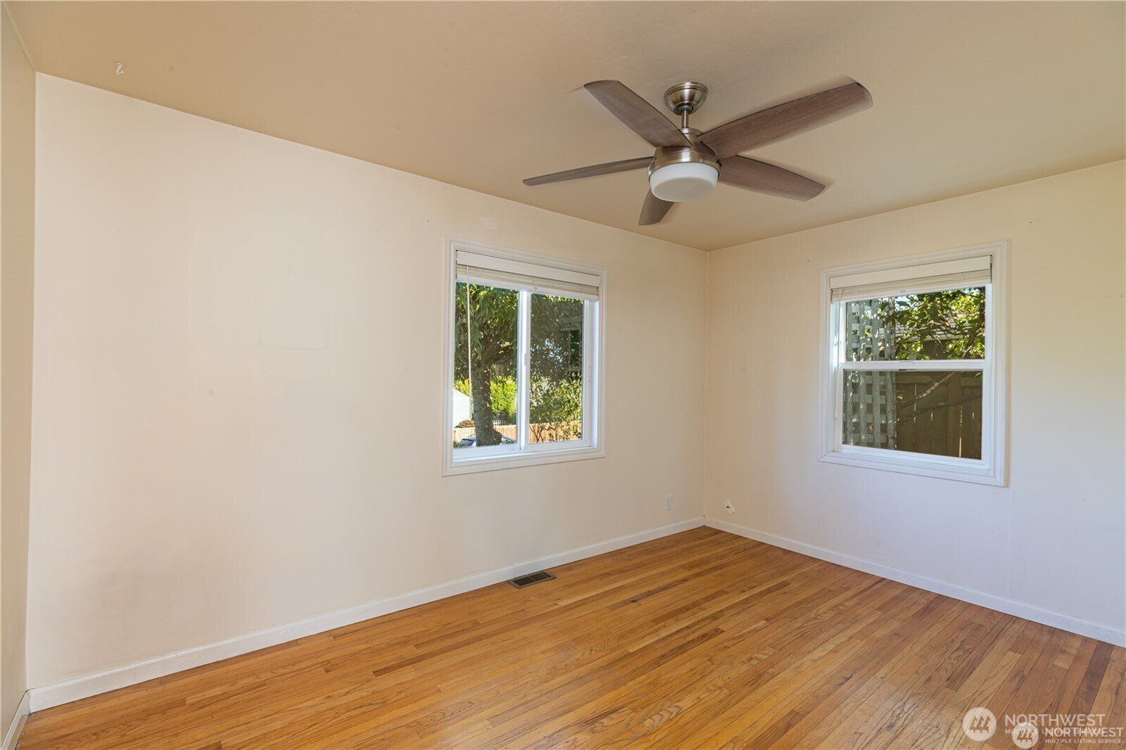 8601 36th Avenue Southwest Seattle, WA 98126 - Photo 15 of 28 a view of an empty room with wooden floor and a window