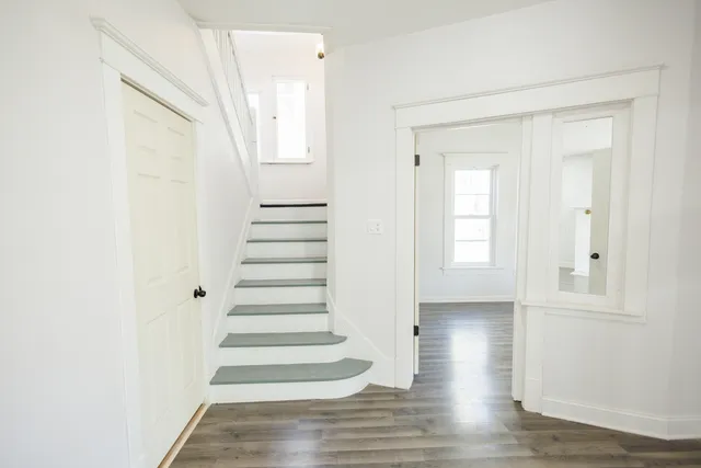 a view of an entryway with wooden floor
