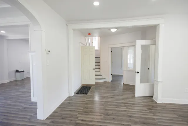 a view of a hallway with wooden floor