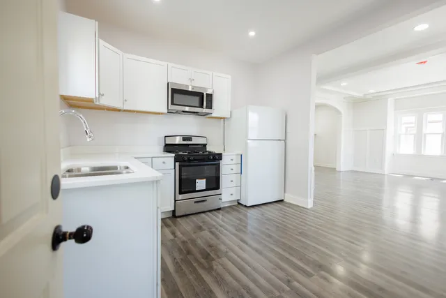 a kitchen with stainless steel appliances a stove refrigerator sink and cabinets