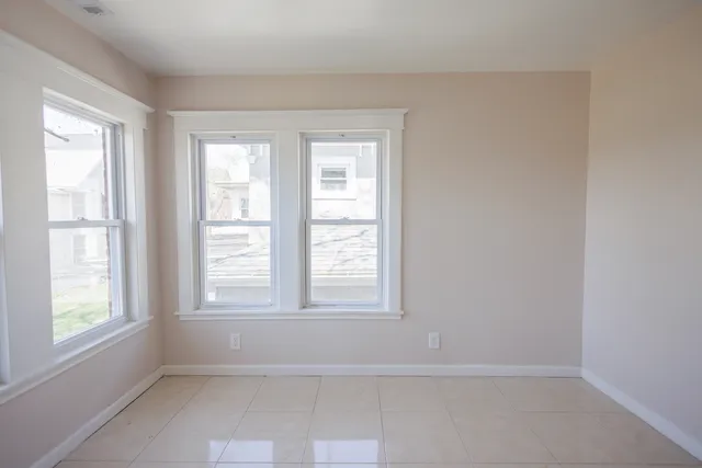 a view of wooden floor and windows in a room