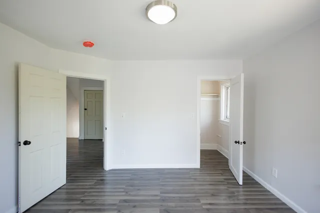 a view of a small space with wooden floor and a window