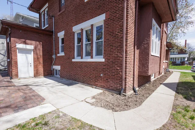 a view of a brick house with many windows