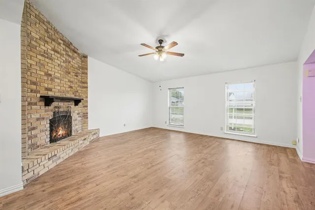 wooden floor in an empty room with a fireplace