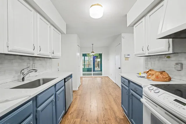 a kitchen with stainless steel appliances granite countertop a sink stove and cabinets