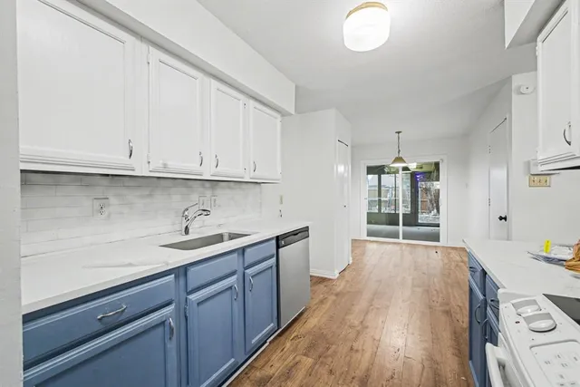 a kitchen with a sink and wooden cabinets