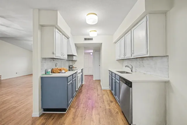 a kitchen with granite countertop a sink and a stove top oven