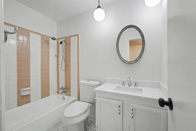 a bathroom with a toilet a sink and a mirror