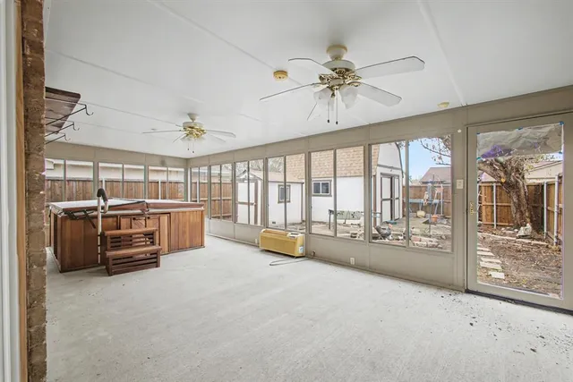 a large white bedroom with furniture and large windows