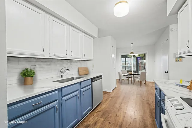 a kitchen with a sink and wooden cabinets