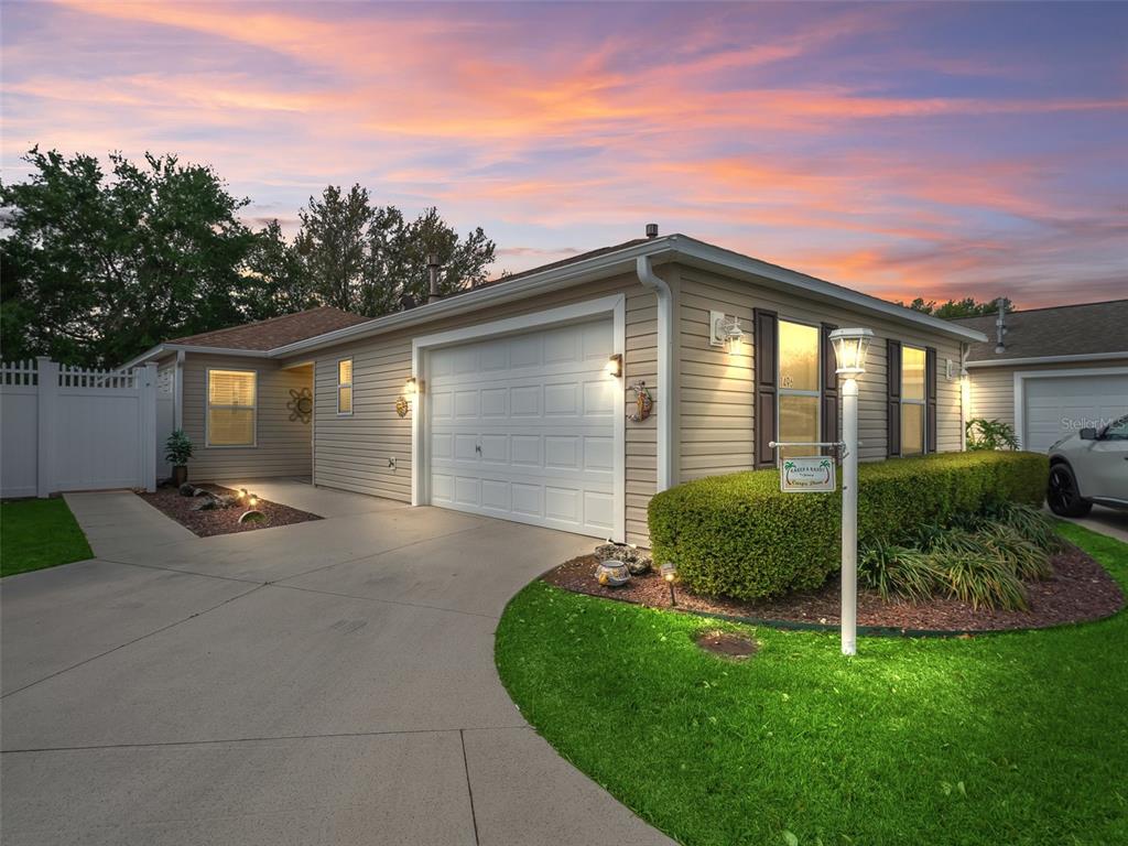 1496 Rosedale Way The Villages, FL 32162 - Photo 1 of 1 a front view of a house with a yard and garage