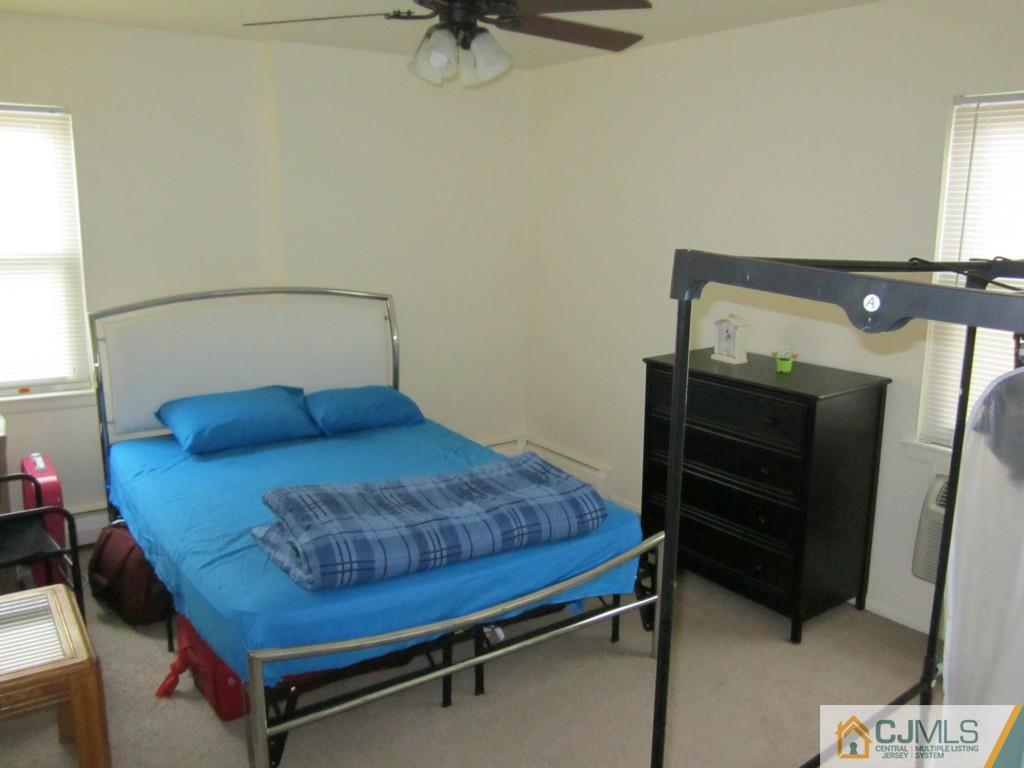 50 Fox Road, Unit 5B Edison, NJ 08817 - Photo 3 of 10 a bedroom with a bed and furniture