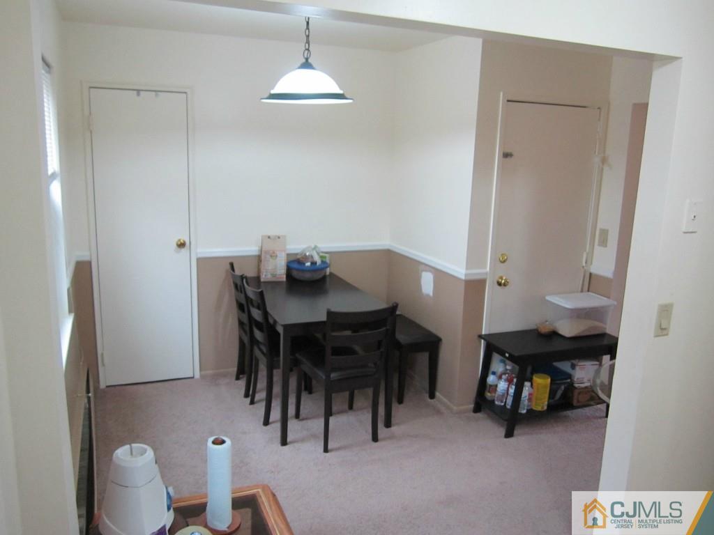 50 Fox Road, Unit 5B Edison, NJ 08817 - Photo 5 of 10 a view of a dining room with furniture and a chandelier