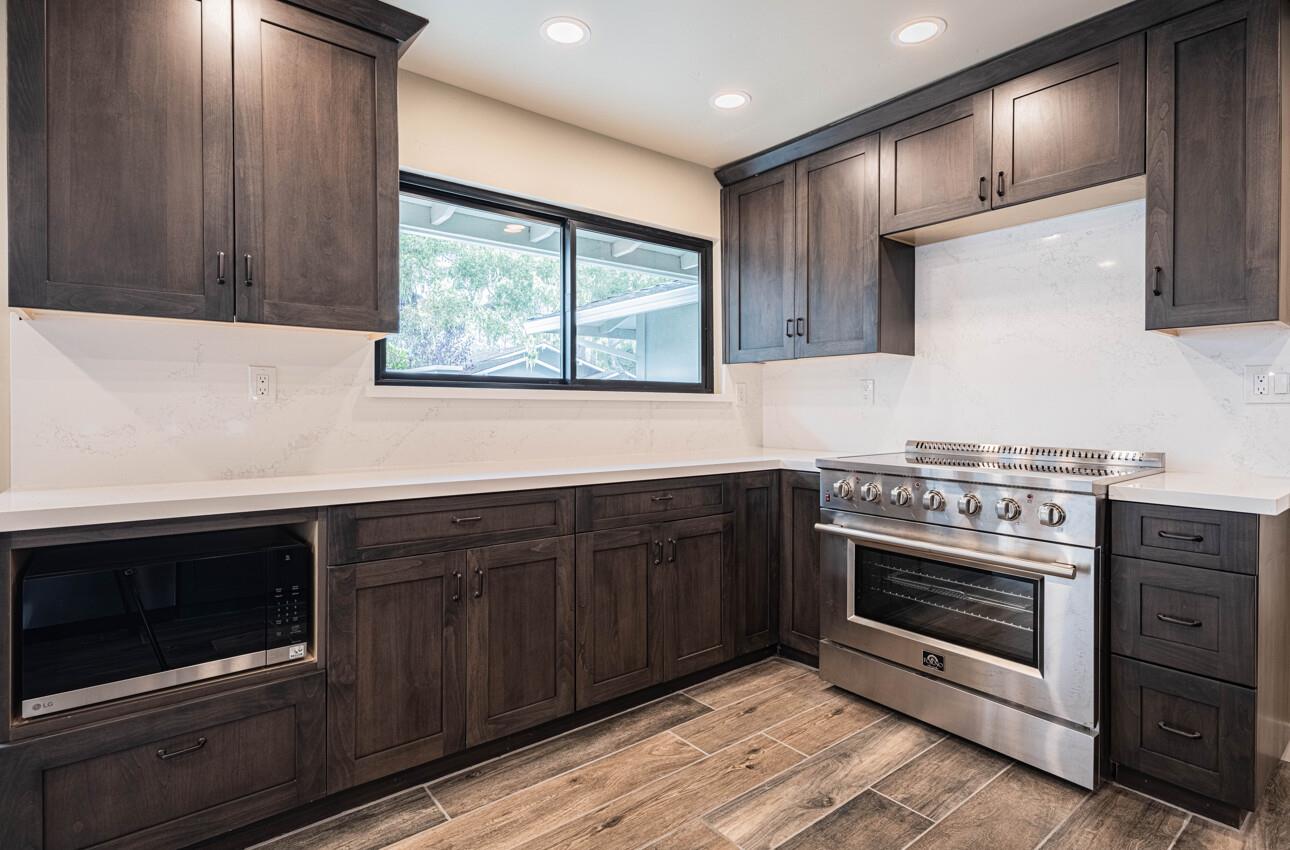 52 Country Club Gate Pacific Grove, CA 93950 - Photo 12 of 37 a kitchen with stainless steel appliances wooden cabinets stove and sink
