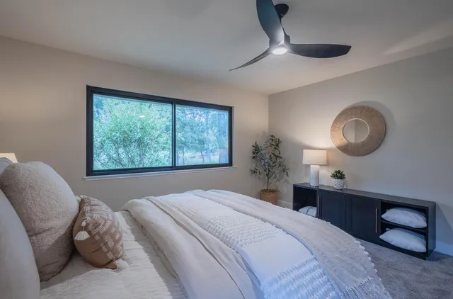 a bedroom with a large bed and a window