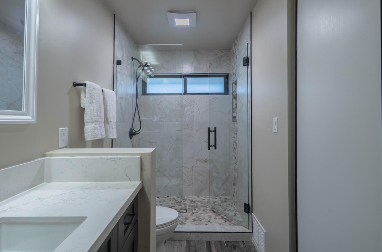 52 Country Club Gate Pacific Grove, CA 93950 - Photo 23 of 37 a bathroom with a granite countertop shower a sink and a mirror