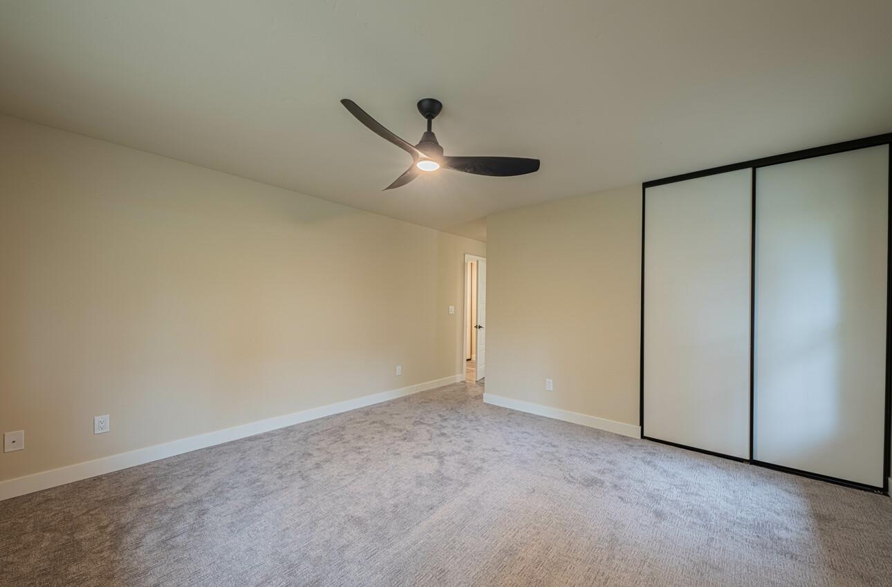 52 Country Club Gate Pacific Grove, CA 93950 - Photo 25 of 37 an empty room with a ceiling fan and a window