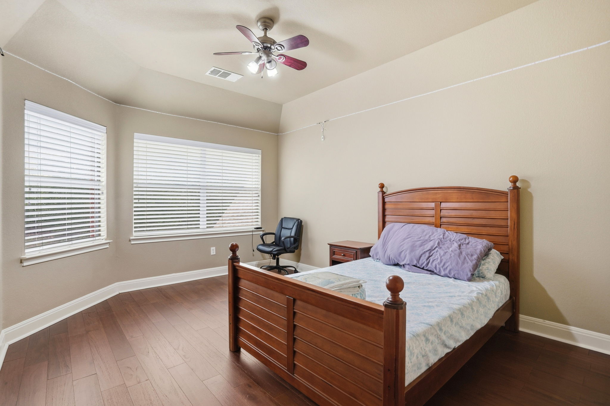 222 Vailco Lane Austin, TX 78738 - Photo 27 of 39 Interior space featuring wood-finish flooring, two large windows with blinds, and neutral-toned walls
