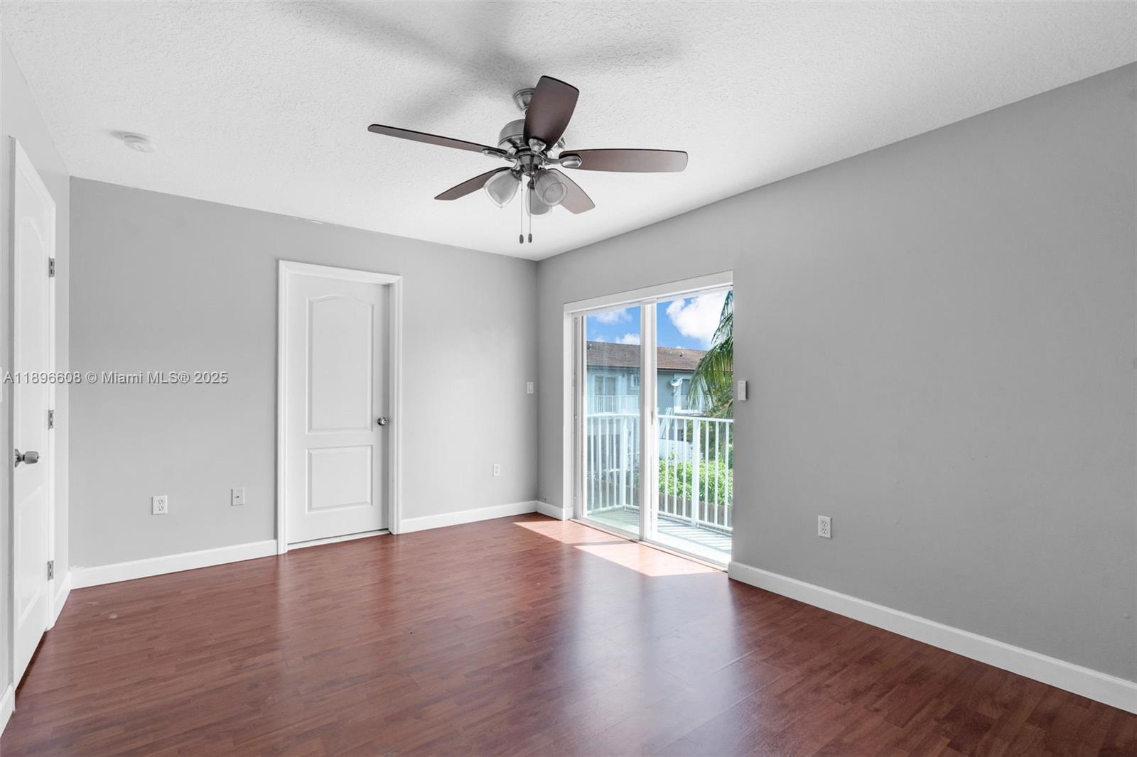 2883 Southwest 129th Terrace, Unit 2883 Miramar, FL 33027 - Photo 12 of 18 a view of an empty room with wooden floor and a window