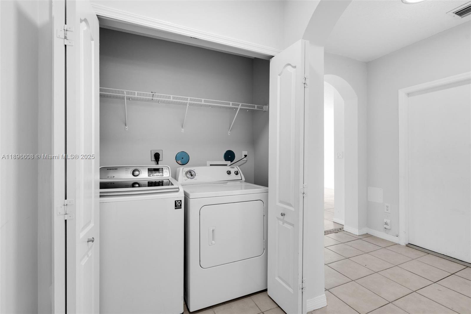 2883 Southwest 129th Terrace, Unit 2883 Miramar, FL 33027 - Photo 14 of 18 a utility room with dryer and washer