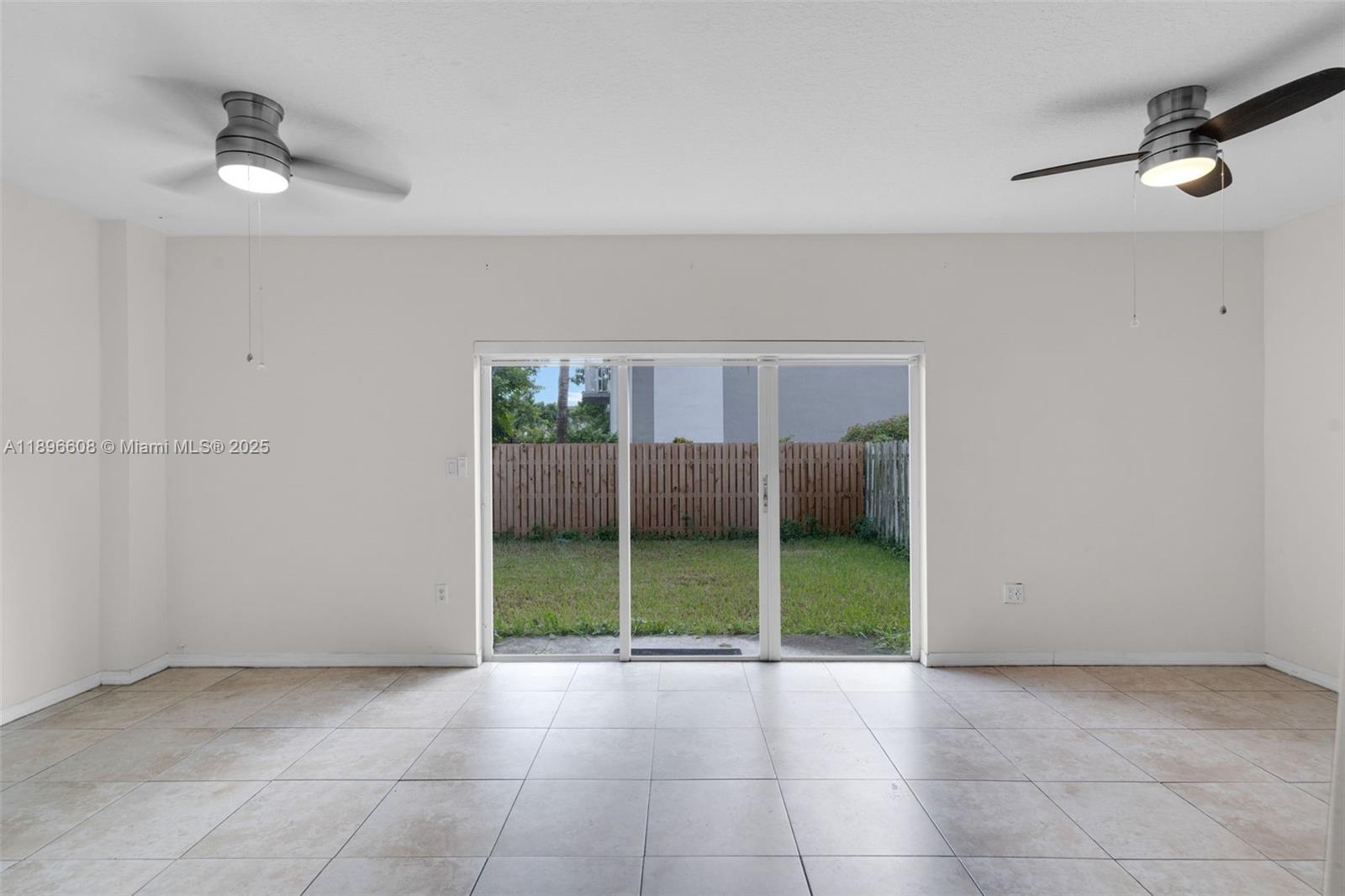 2883 Southwest 129th Terrace, Unit 2883 Miramar, FL 33027 - Photo 5 of 18 a view of an empty room with a window