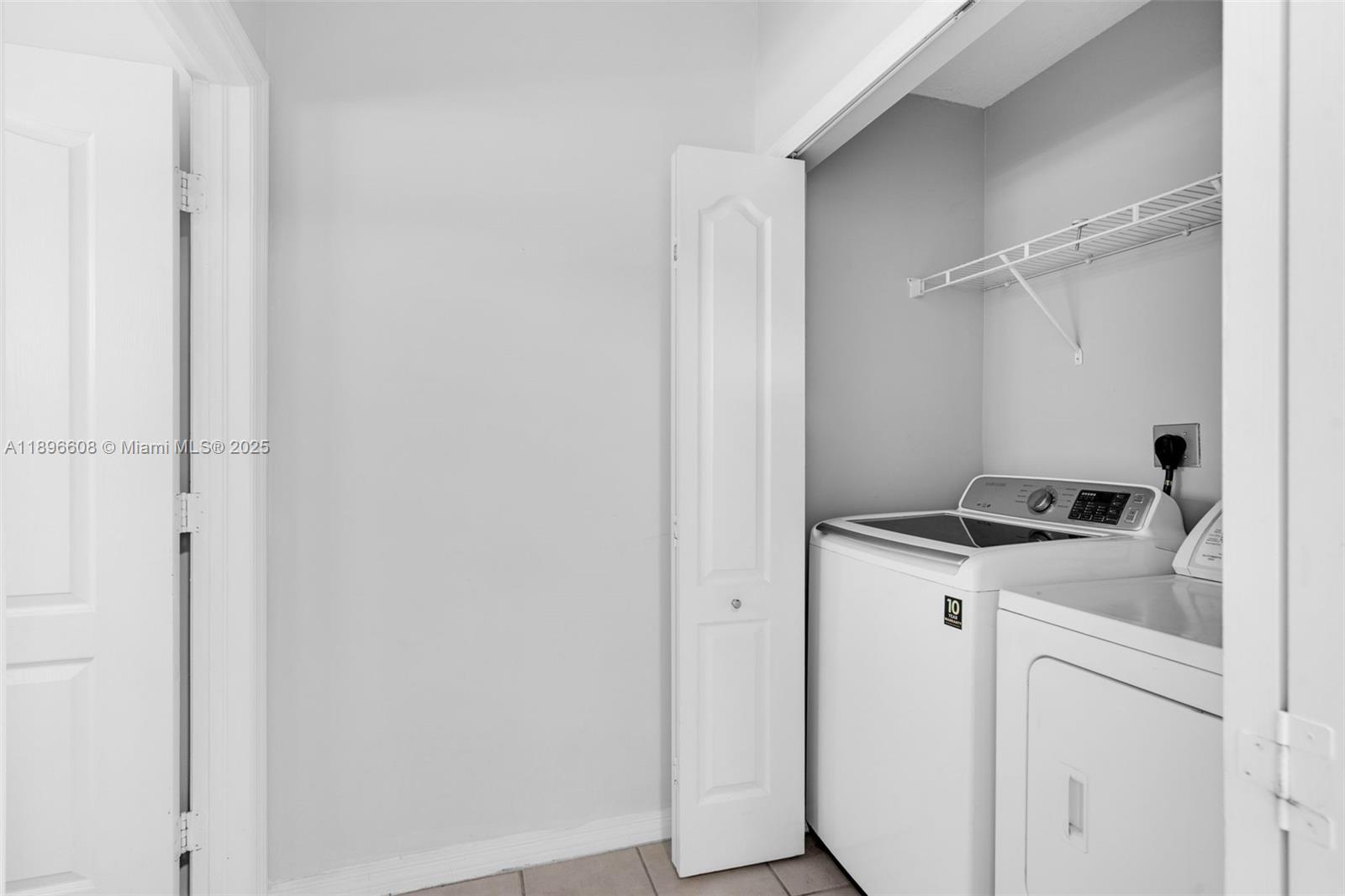 2883 Southwest 129th Terrace, Unit 2883 Miramar, FL 33027 - Photo 7 of 18 a utility room with dryer and washer