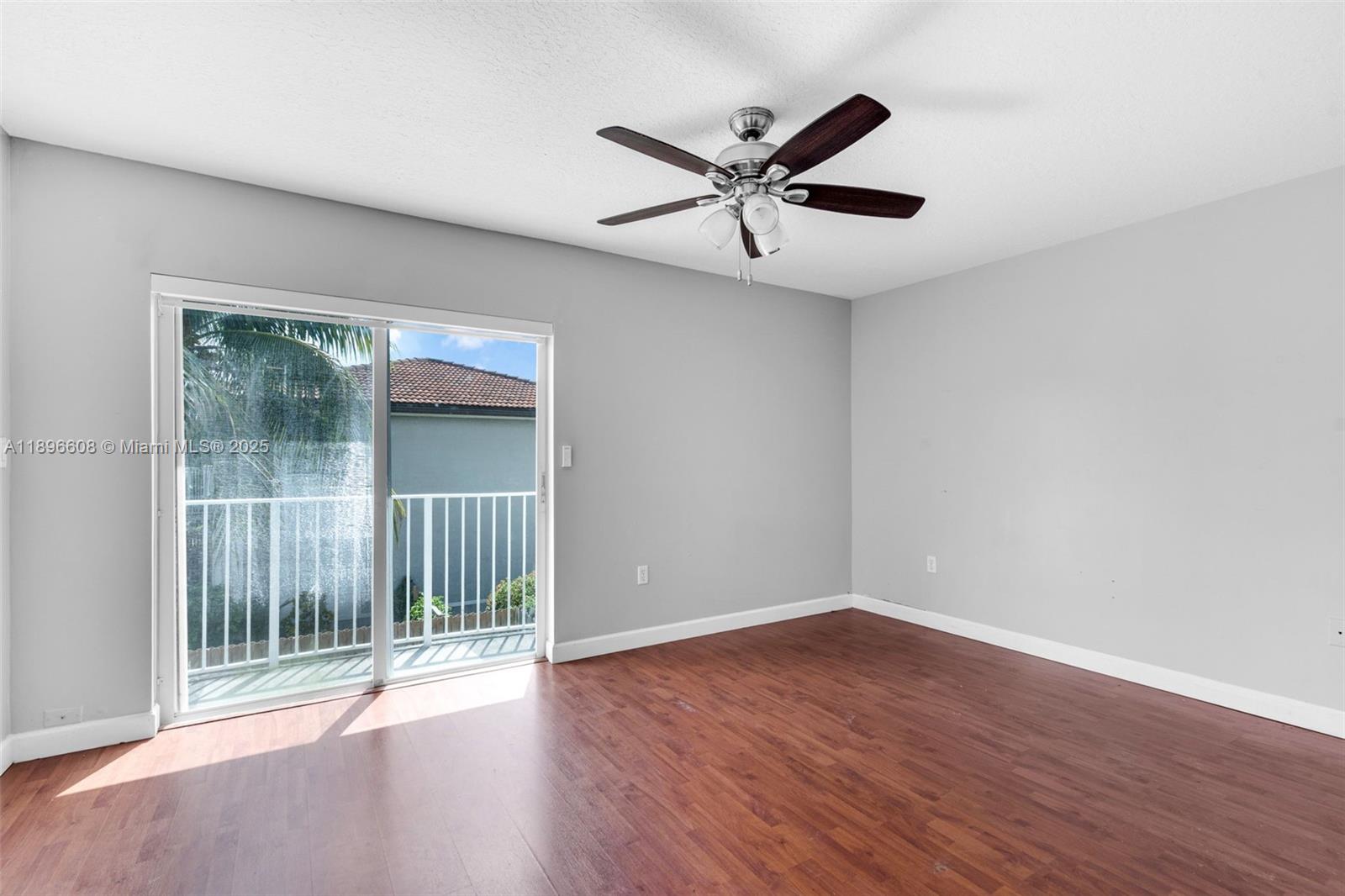 2883 Southwest 129th Terrace, Unit 2883 Miramar, FL 33027 - Photo 10 of 18 a view of empty room with wooden floor and fan