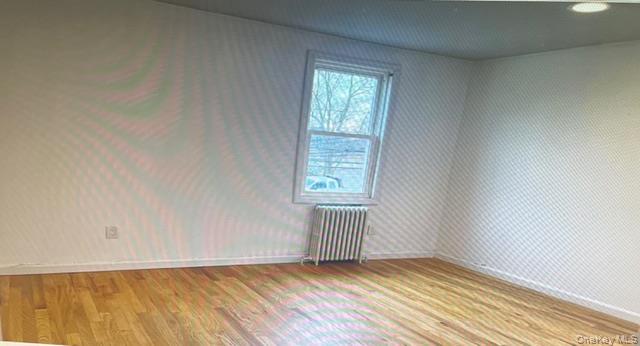 45 James Street Inwood, NY 11096 - Photo 7 of 11 an empty room with wooden floor and windows