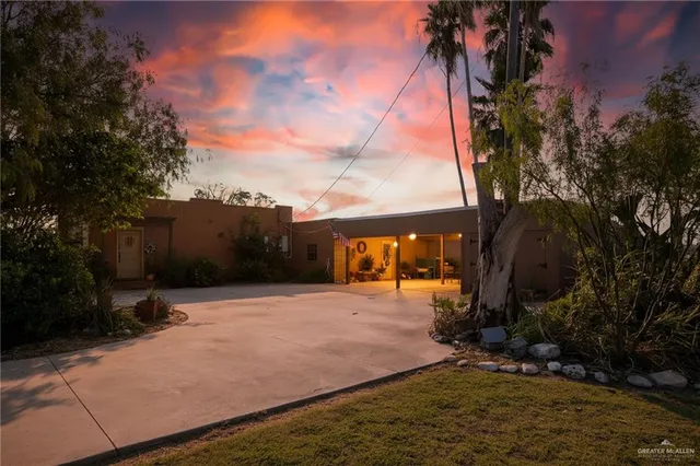 a backyard of a house with table and chairs