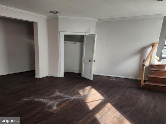609 East 41st Street Baltimore, MD 21218 - Photo 4 of 9 a view of an empty room with wooden floor and a window