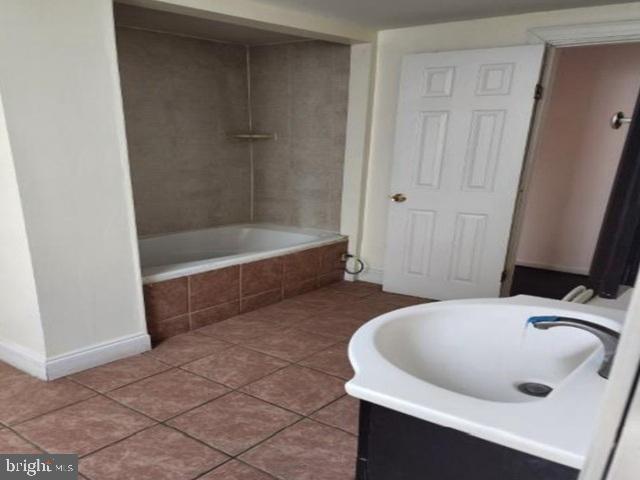 609 East 41st Street Baltimore, MD 21218 - Photo 9 of 9 a bathroom with a sink and a bathtub