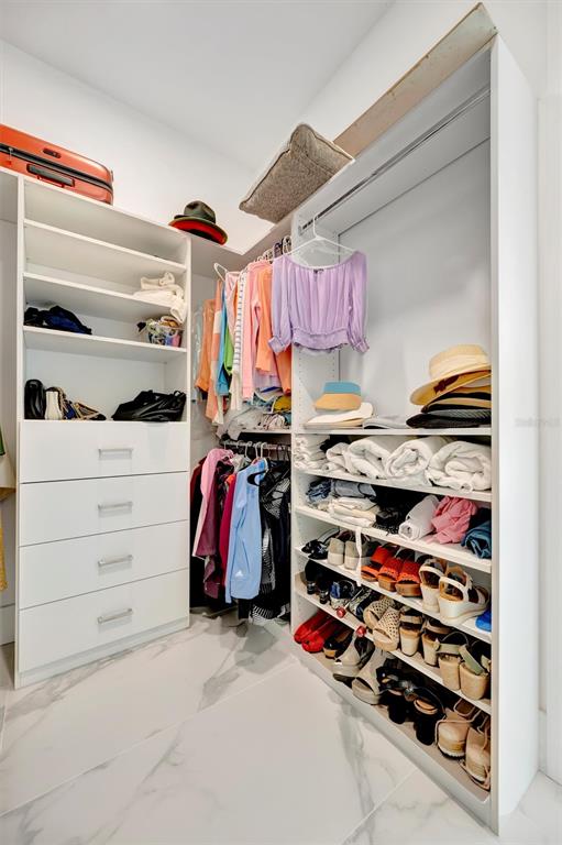916 Highland Street Sarasota, FL 34234 - Photo 20 of 48 a view of walk in closet with clothes and shoes