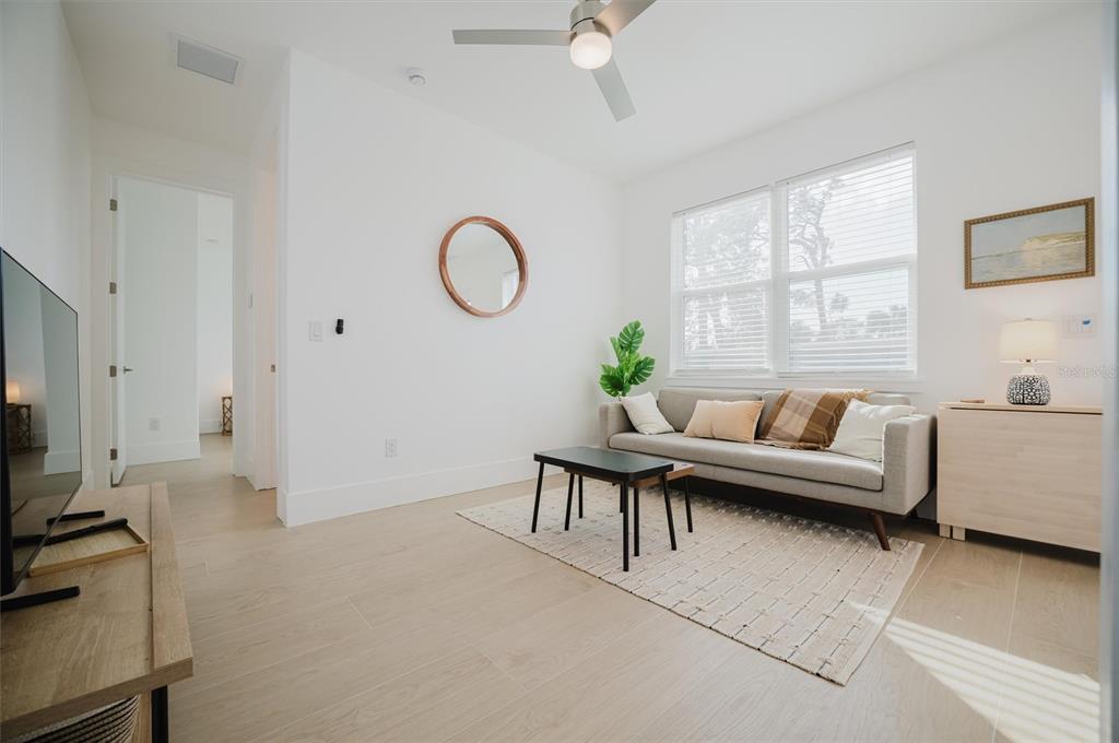 916 Highland Street Sarasota, FL 34234 - Photo 23 of 48 a living room with furniture a flat screen tv and a window