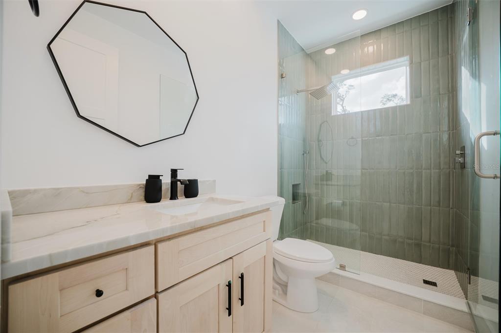 916 Highland Street Sarasota, FL 34234 - Photo 35 of 48 a bathroom with a granite countertop sink a toilet and shower