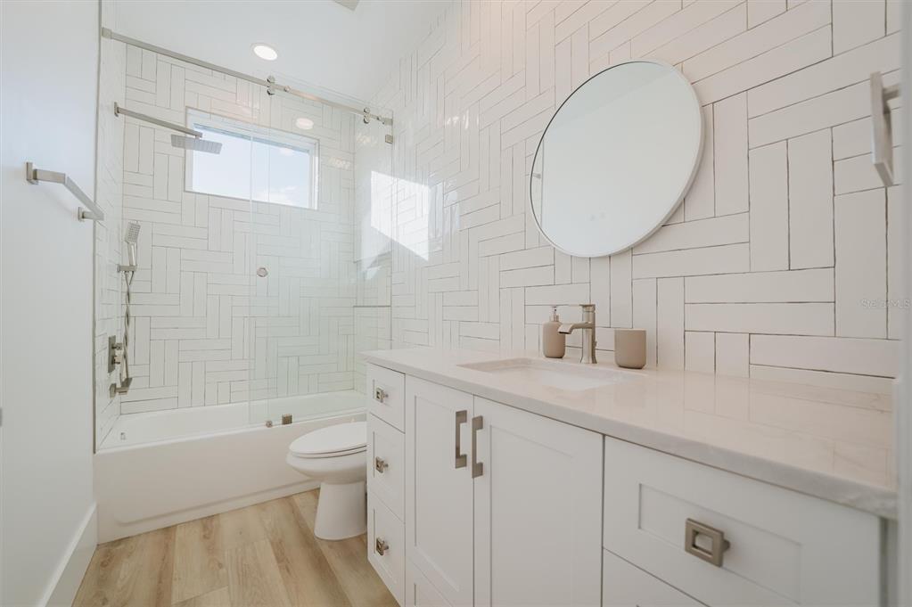 916 Highland Street Sarasota, FL 34234 - Photo 37 of 48 a bathroom with a sink a toilet and a mirror