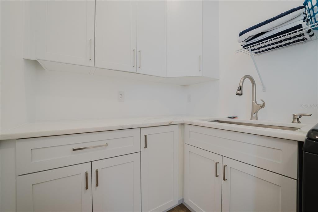 916 Highland Street Sarasota, FL 34234 - Photo 39 of 48 a view with cabinets and washer dryer