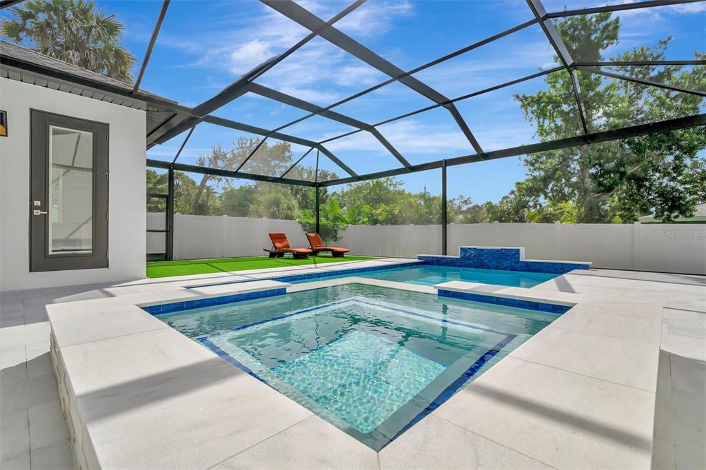 916 Highland Street Sarasota, FL 34234 - Photo 5 of 48 a view of a backyard with a tub and wooden fence
