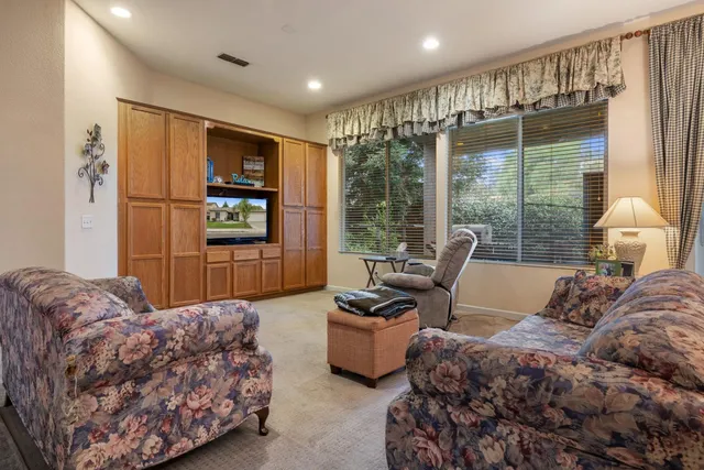 a bedroom with bed couch and window