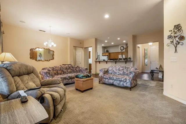 a large living room with furniture and a chandelier