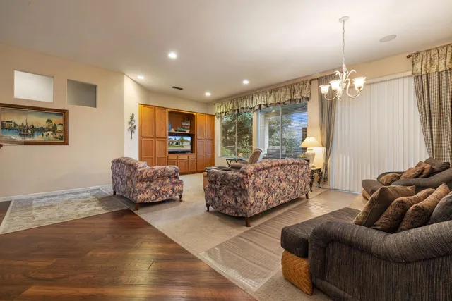 a living room with furniture and a chandelier