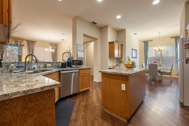 a large kitchen with lots of counter space and stainless steel appliances