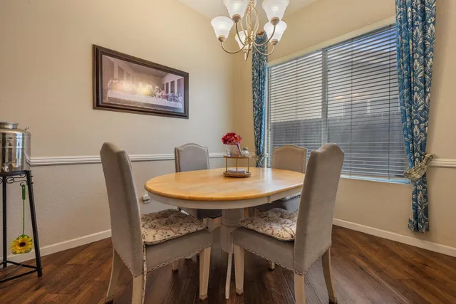 a view of a dining room with furniture wooden floor and chandelier