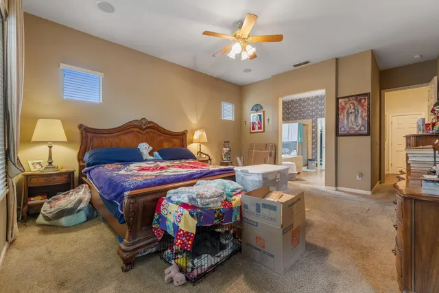 a bedroom with a bed and a chandelier