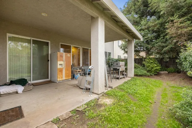 a view of a house with backyard and porch