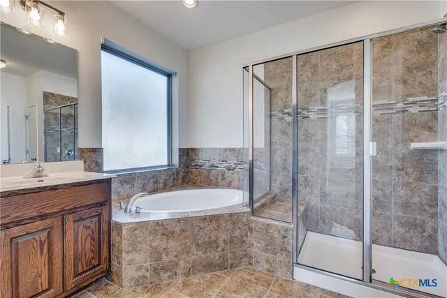 a bathroom with a granite countertop sink a mirror and a shower