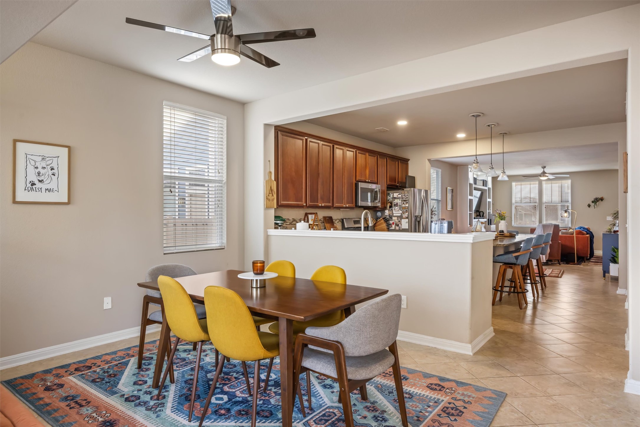 1117 Nevarez Kyle, TX 78640 - Photo 14 of 32 a kitchen with stainless steel appliances kitchen island granite countertop a dining table chairs and a refrigerator