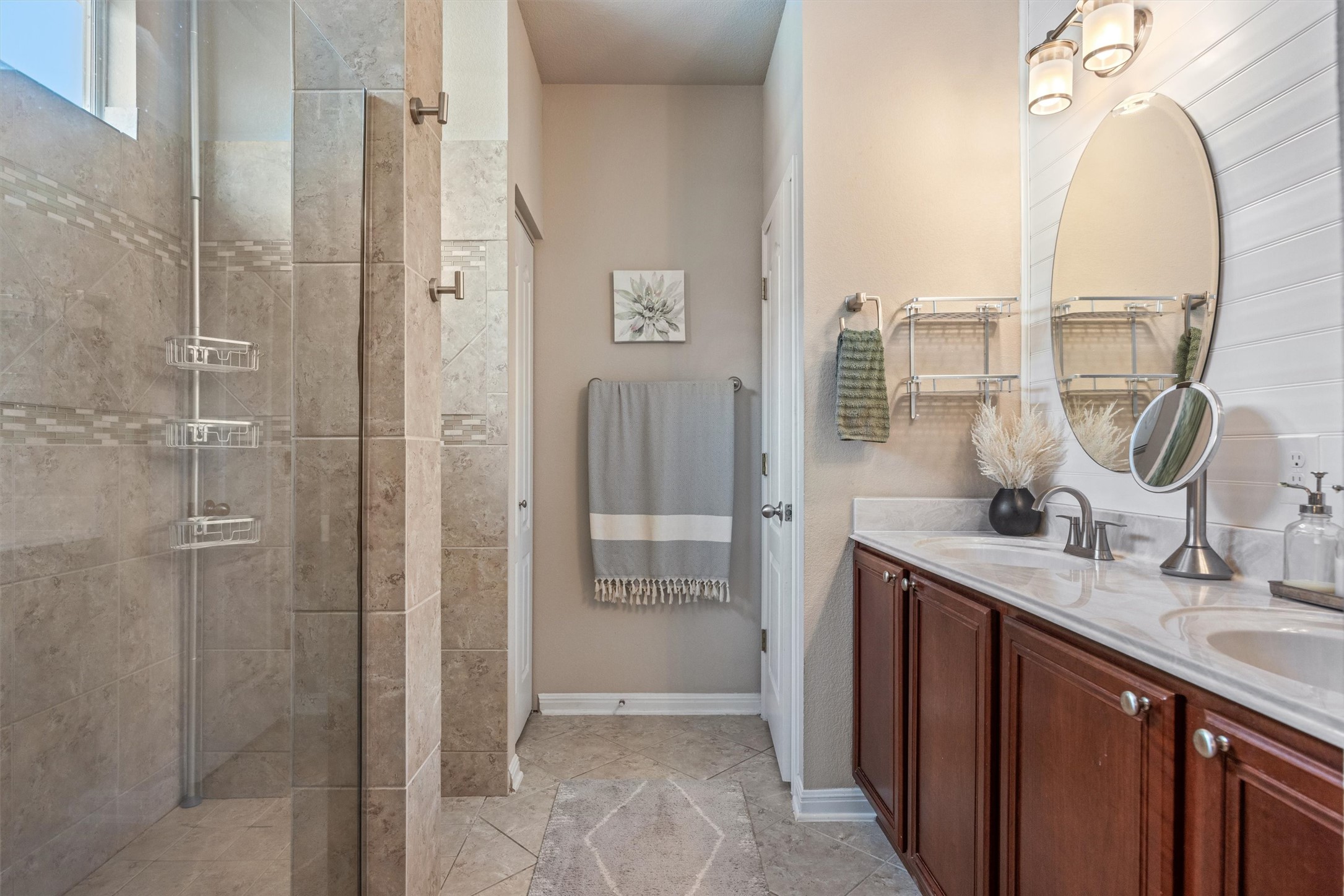 1117 Nevarez Kyle, TX 78640 - Photo 26 of 32 a bathroom with a double vanity sink a mirror and a shower