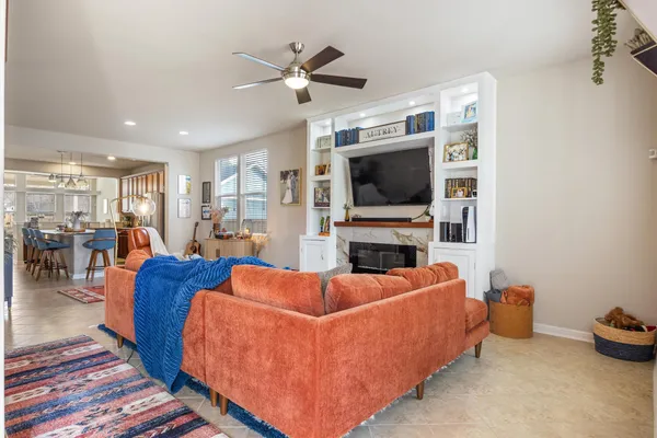 a living room with furniture fireplace and flat screen tv