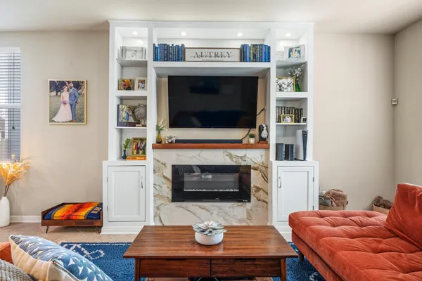 a living room with furniture a table and a large window