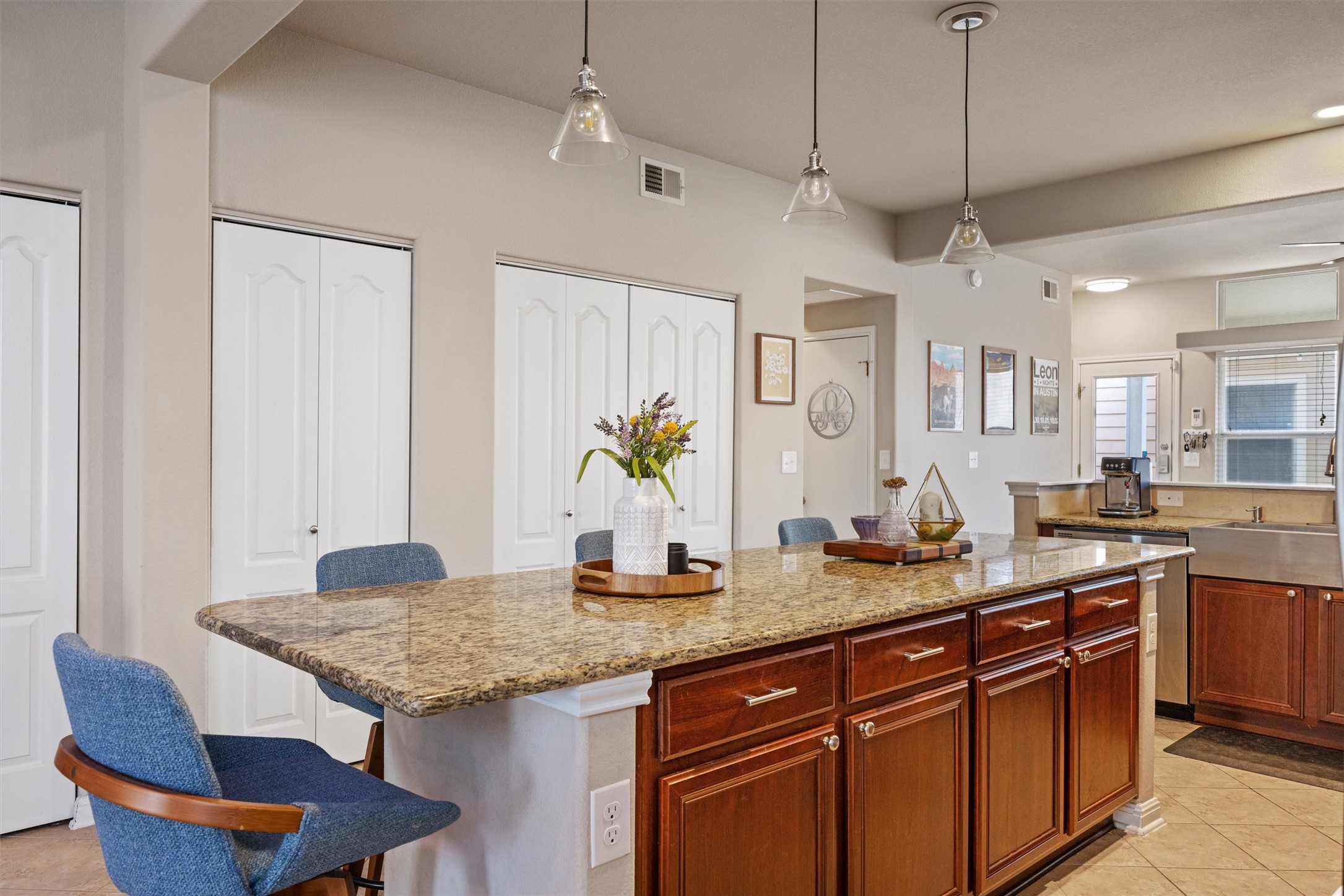 1117 Nevarez Kyle, TX 78640 - Photo 7 of 32 a kitchen with granite countertop kitchen island a table and chairs in it